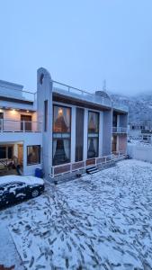 a apartment building with snow on the ground at The Swat House in Swat