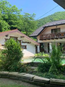 a house with a porch and a balcony on it at Gostynets in Yaremche