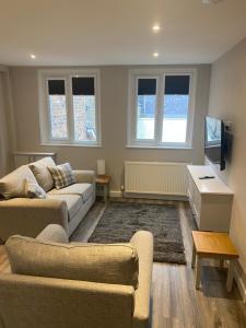 a living room with a couch and a tv at THE ESK - Modern 1 bedroom apartment in centre of Melrose. in Melrose