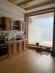 a large kitchen with a large window in the middle at The Swat House in Swat