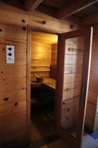 a room with a wooden door and a wooden floor at The Lodge At Creel Eco - Hotel & Spa in Creel