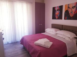 a bedroom with a bed with two white towels on it at B&B Del Corso in Colleferro +27 photos