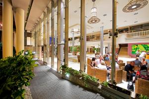 people sitting in a restaurant in a shopping mall at Marylanza Suites & Spa in Playa de las Americas