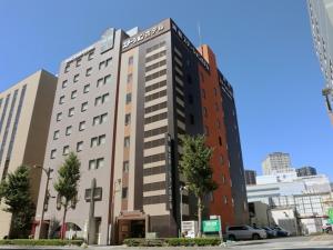 a tall building in the middle of a city at Hamamatsu Station Hotel - Vacation STAY 65834 in Hamamatsu