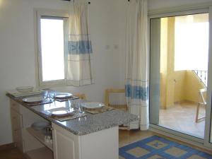 a kitchen with a counter and a large window at Residence Floreal in San Pasquale +70 photos