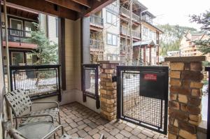 a balcony with a gate and chairs on a building at Beautiful Fraser Crossing Founders Pointe Condo with Upgraded Furnishings condo in Winter Park