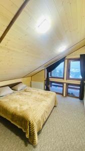 a bedroom in a boat with a bed and a window at Бо&Не in Yablunytsya
