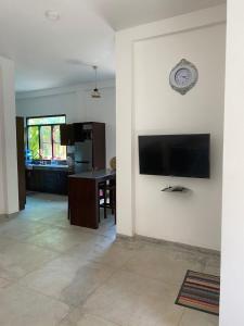 a living room with a flat screen tv on a wall at Villa Freiheit Himmel in Bentota