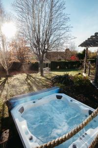 a jacuzzi tub in the yard of a house at Large Holiday Home perfect for family gatherings in Angus