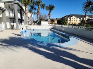 a swimming pool in a yard with palm trees at Baymont by Wyndham Marianna in Marianna