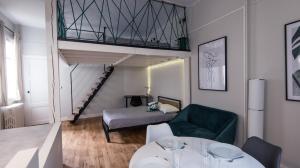 a living room with a couch and a bed and a staircase at Hypercentre - Gare - La Tour'Angel in Tours