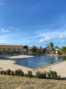 a swimming pool in front of a building at Santo Mar Em São Miguel do gostoso in Touros