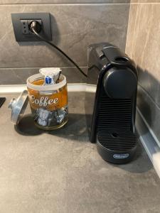 a toaster sitting next to a cup of coffee at Ginevra Home in Sesto San Giovanni