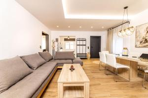 a living room with a couch and a table at Welcome Home Meteora - Kalampaka! in Kalabaka