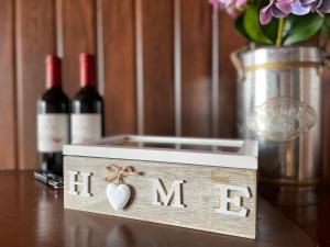 a wooden box with the word mom with two bottles of wine at Cabañas Las Lengas in Puerto Natales