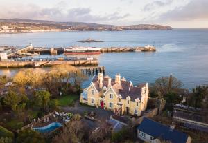 an aerial view of a house on the water at Ravenscliffe Lodge in Douglas