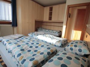 a room with three beds in a room at Brand new apartment in Livigno near ski area in Livigno
