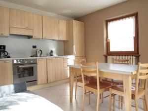 a kitchen with a table and chairs in a room at Brand new apartment in Livigno near ski area in Livigno