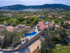 an aerial view of a house with a swimming pool at Dalmatian stone Villa Burica in Vinišće