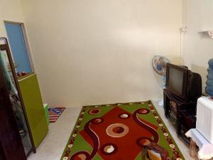a living room with a carpet on the floor at Sella Guest House in Banyuwangi