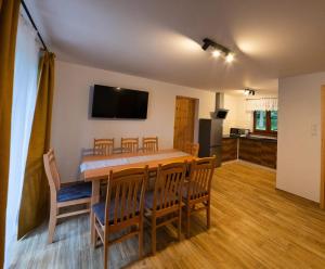 a kitchen and dining room with a table and chairs at Dziubanowo in Sanok