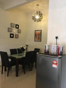 a dining room with a table and a refrigerator at KS Lavender Kuala Kangsar in Kuala Kangsar