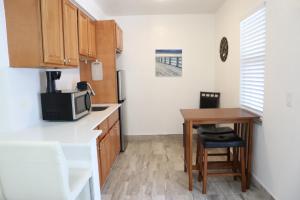 a small kitchen with a table and a microwave at SII Luxury 1 Bedroom close to the beach in West Palm Beach