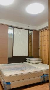 a bedroom with two beds and a large window at KTC TRADE CENTRE in Kota Bharu