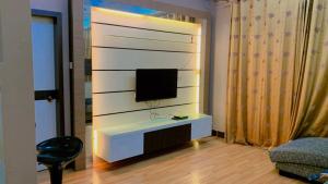 a living room with a tv on a wall at KTC TRADE CENTRE in Kota Bharu