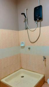 a shower in a bathroom with a bath tub at KTC TRADE CENTRE in Kota Bharu +2 photos