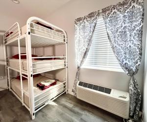 a bedroom with bunk beds and a window at Pineapple Hostel in Los Angeles