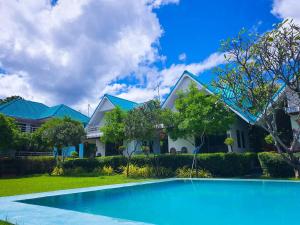 a house with a swimming pool in front of a house at Dreampark resort in Kanchanaburi City