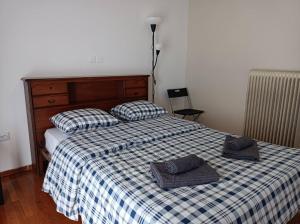 a bed with two hats and two pillows on it at Rooms in the apartment (Leontiou) in Athens