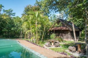 a resort with a swimming pool and a house at Palm Village Resort & Spa in Siem Reap