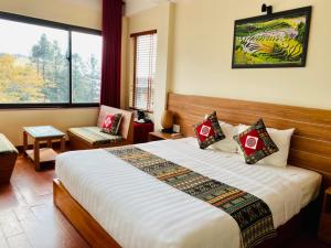 Postel nebo postele na pokoji v ubytování Sapa Garden Hotel