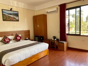 Postel nebo postele na pokoji v ubytování Sapa Garden Hotel