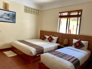 Postel nebo postele na pokoji v ubytování Sapa Garden Hotel