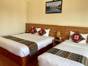 Postel nebo postele na pokoji v ubytování Sapa Garden Hotel