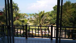 a balcony with a view of the beach and palm trees at Sea Lavender Villa in Ko Chang