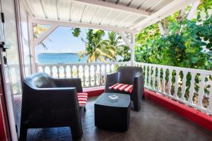 a porch with chairs and a view of the ocean at Colibri Beach Villas in Trou d'Eau Douce