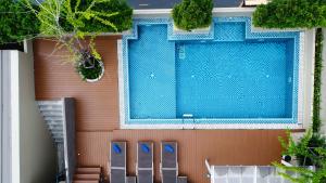 a swimming pool on the side of a house at Ramada Ekamai in Bangkok