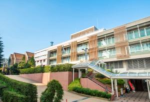 a building with a staircase in front of a building at Hotel Grand Hill Ichigaya in Tokyo