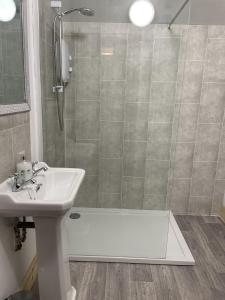 a bathroom with a shower and a sink and a shower at Galloway Farmstay Broughton in Newton Stewart