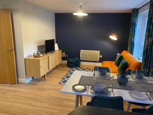 a living room with a couch and a table at Lime Tree Apartment in Coventry