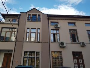 a large white building with windows on the side of it at The Old House guest rooms and apartament in Plovdiv