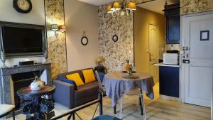 a living room with a table and a couch at " Le Cher Passant " in Savonnières