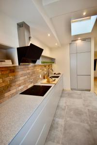 a kitchen with white cabinets and a sink at Kraków Krib in Krakow