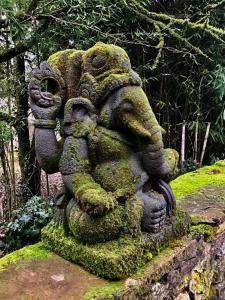 a statue of an elephant covered in moss at Villa Léovil in Saint-Pompont