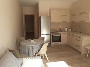 eine Küche mit einem Tisch mit Stühlen und einem Kühlschrank in der Unterkunft Diane Luxury Rooms in Skala Kallirachis