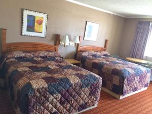 a hotel room with two beds in a room at Lake Shore Motel in Mannford
